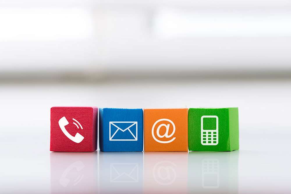 Colorful contact us blocks, each with a white icon for telephone, email, social media @mention, and mobile phone