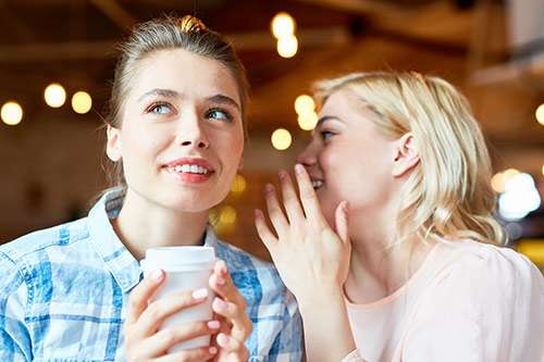 Two women talking over coffee.