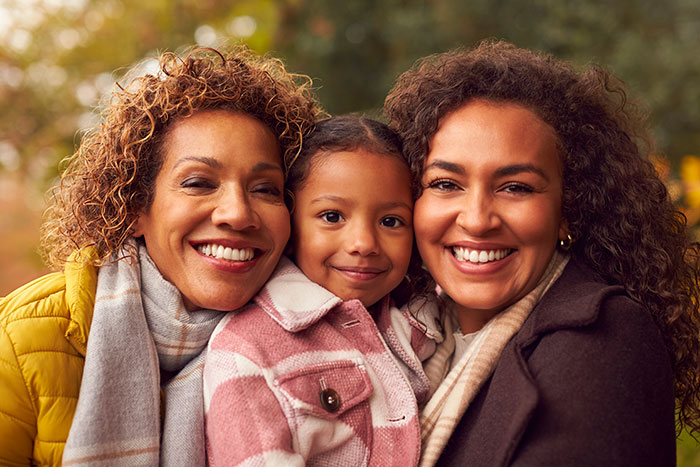 A family portrait with three generations of women: mother, daughter, and baby granddaughter