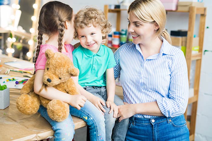 Mom with two young kids thinking about the pros and cons of child life insurance