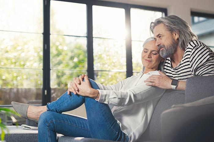 Senior couple relaxing together, enjoying retirement because they have guaranteed universal life insurance