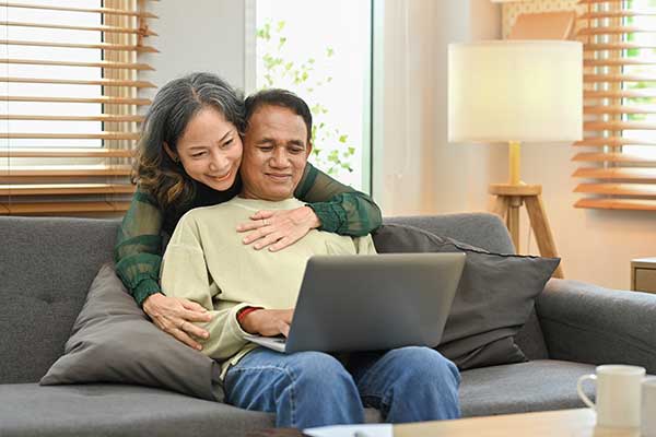 Senior couple using a laptop to look up details about the term life insurance policy as it matures