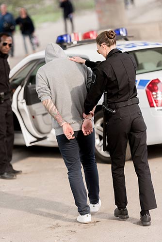 Policewoman arresting a man