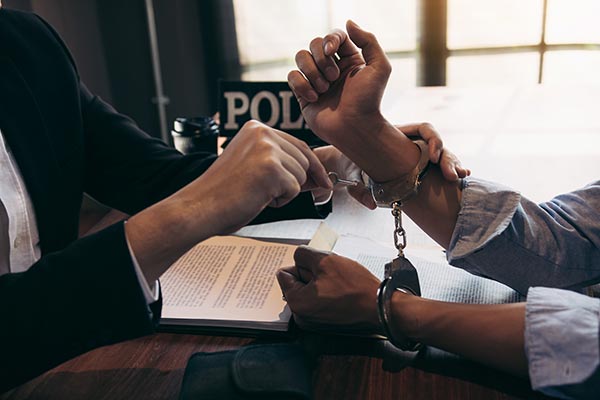 Man in handcuffs, symbolizing the question of getting life insurance for felons