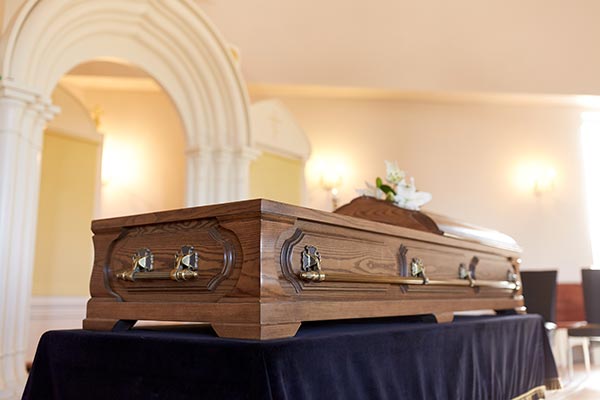 Wooden coffin on a dais in a church for a funeral