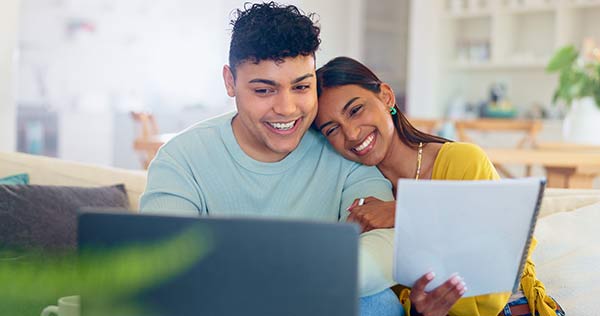 Young couple checking their life insurance cash value account balance online