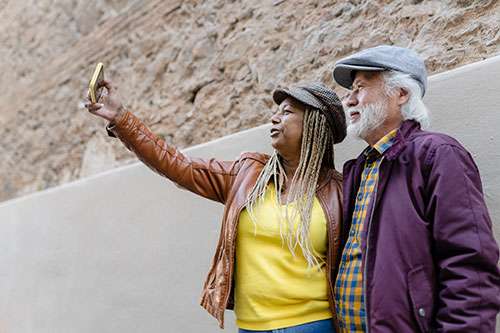 A happy interracial couple take a selfie.