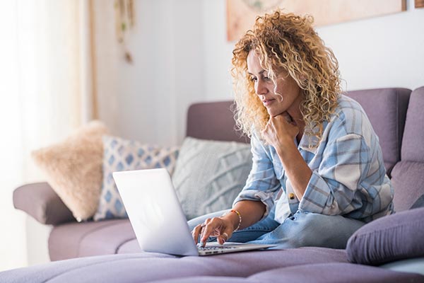 Woman researching ‘is whole life insurance an asset’ on her laptop