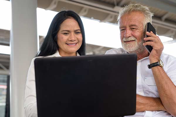 Senior couple using their laptop to look up ‘do banks buy life insurance’