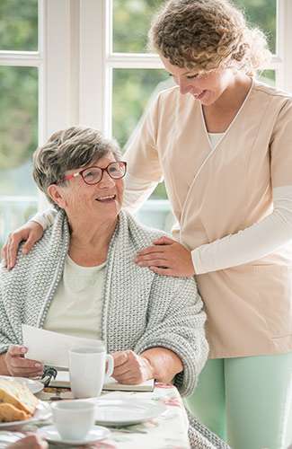 positive-senior-lady-with-term-life-insurance-questions Senior lady with a nurse asking questions about term life insurance.