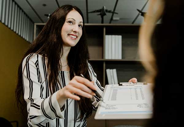 Woman showing her accountant a receipt for paid up additions for her life insurance policy