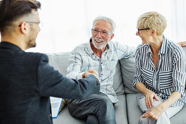 Senior couple meeting with a life insurance agent to convert term life insurance to whole life