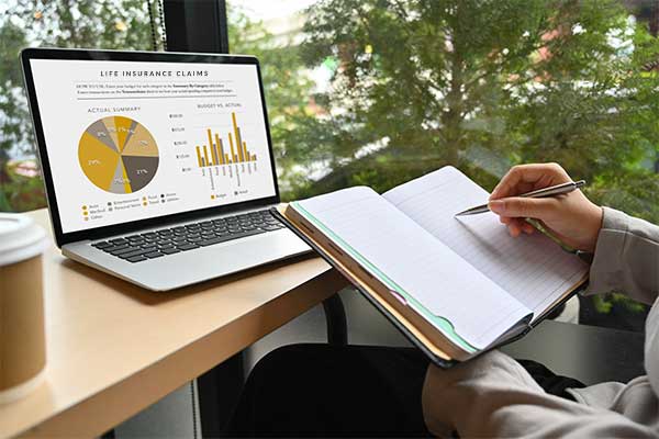 Woman using laptop to look up ‘does term life insurance cover accidental death?’