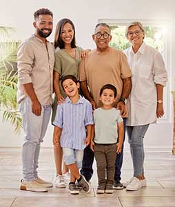 happy-family-portrait-with-kids-parents-and-grandparents Happy family portrait with kids, parents and grandparents smiling in their home.